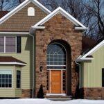 Home in winter with brick, shake shingles an metal siding