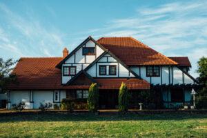 European style home with orange shingles